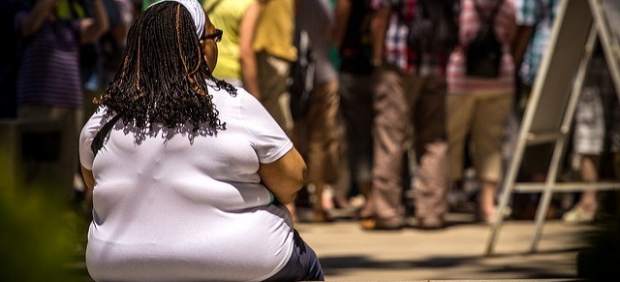Mujer obesa sentada en un banco